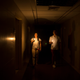 Relatives of a patient use candles to navigate a darkened clinic in Caracas on March 7, 2019.